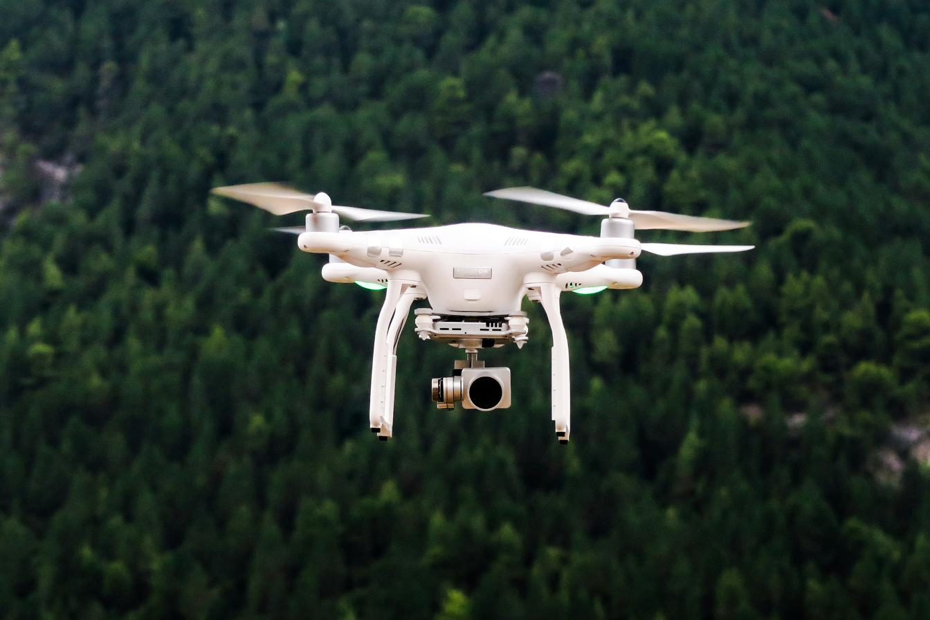 A drone over a wooded landscape